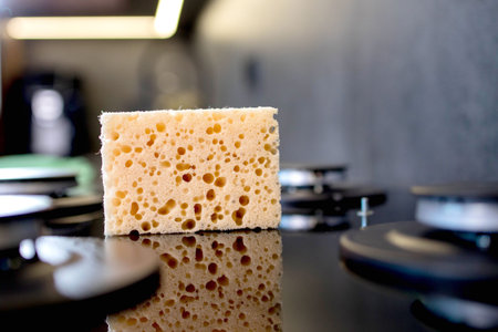 Orange sponge for cleaning gas stove, cleaning the kitchen.