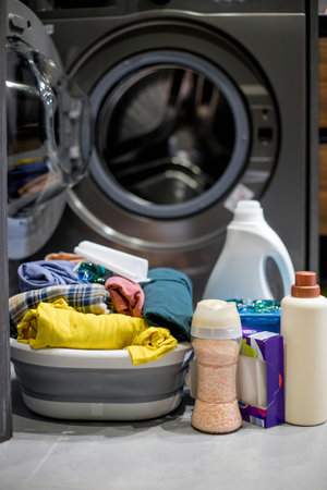 Laundry detergent near the washing machine. Washing dirty clothesの写真素材