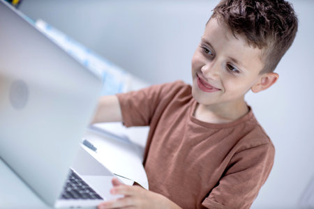 Little boy using laptop for homework. Distance education.の写真素材