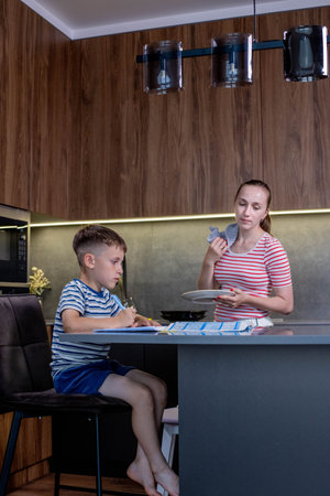 Mother Helping Son With Homework At Table.の写真素材