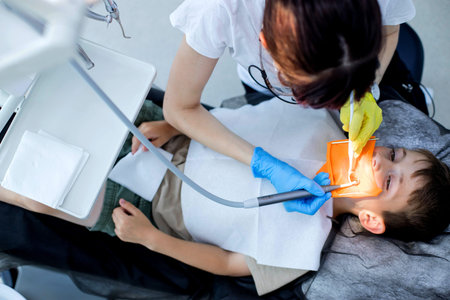 Process of installing a dental cofferdam for dental treatment on child.の写真素材