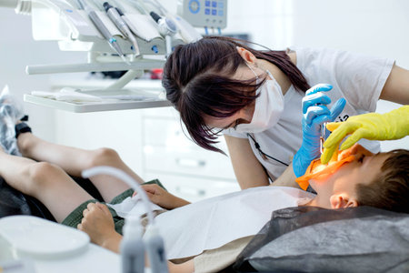 Process of installing a dental cofferdam for dental treatment on child.の写真素材