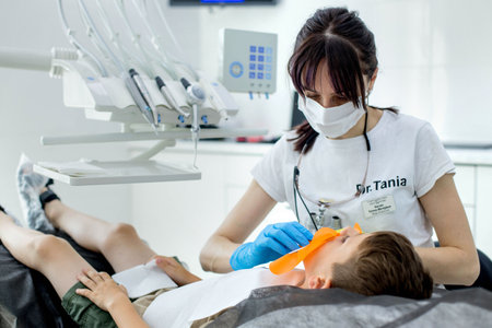 Process of installing a dental cofferdam for dental treatment on child.の写真素材
