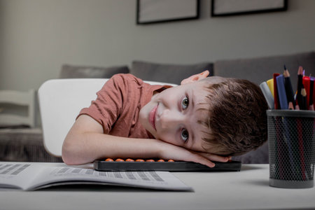 Boy is thinking about solving the problem. Mental arithmetic. Adding numbers.の写真素材