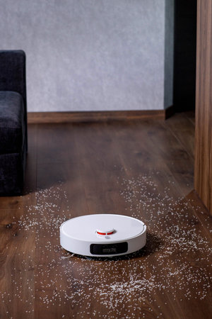 Efficient robotic vacuum cleaner cleans everything automatically near its station.の写真素材