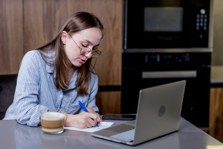 vHome, remote job and business woman on laptop work in kitchen.の写真素材