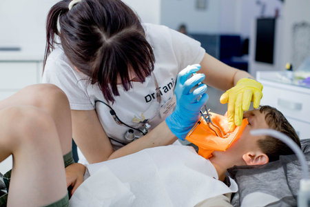 Process of installing a dental cofferdam for dental treatment on childの写真素材