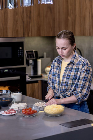 Woman Slicing Ingredients for Quiche in the kitchenの写真素材