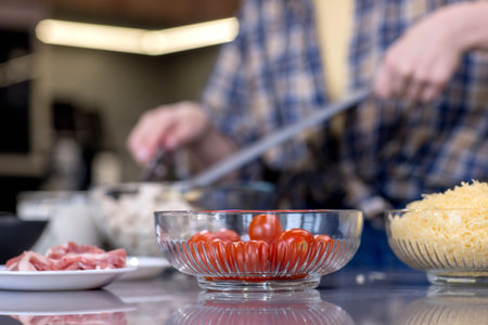 Young woman preparing quiche in the kitchen.の写真素材