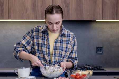 Young woman preparing quiche in the kitchen.の写真素材