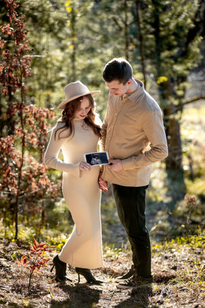 A Couple Joyfully Celebrating Their Pregnancy Announcement Surrounded by Beautiful Nature.の写真素材