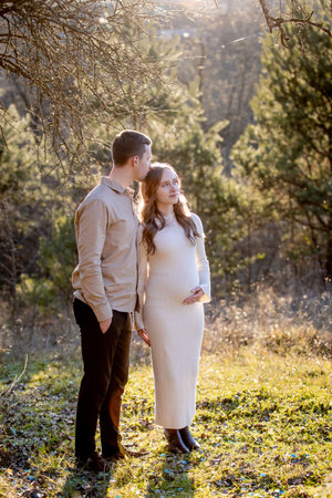 A Couple Joyfully Celebrating Their Pregnancy Announcement Surrounded by Beautiful Nature.の写真素材