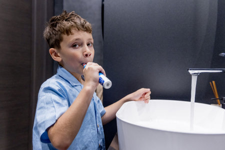 Cute little boy brushing his teeth in the bathroom.の写真素材