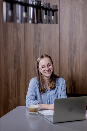 vHome, remote job and business woman on laptop work in kitchen.の写真素材