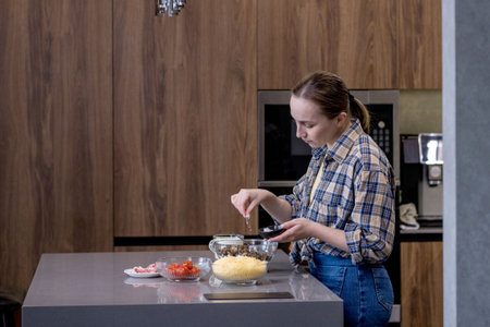 Young woman preparing quiche in the kitchen.の写真素材