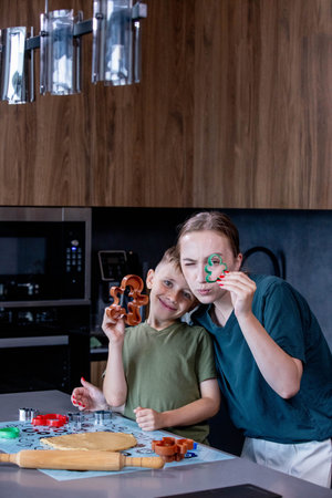 Mother and son bond over making gingerbread in their stylish kitchen.の写真素材