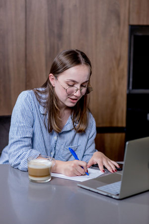 remote job and business woman on laptop work in kitchen.の写真素材