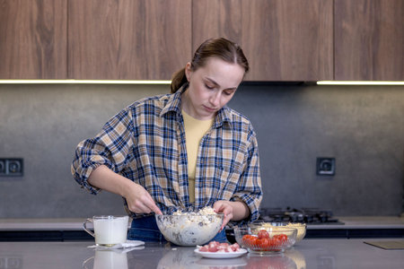 Young woman preparing quiche in the kitchen.の写真素材