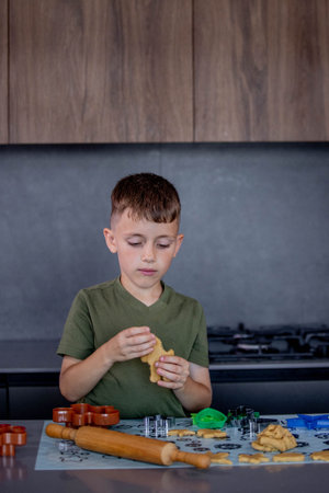 A Child Engaging in Baking Fun with Colorful Cookie Cutters in a Modern Kitchen Space.の写真素材
