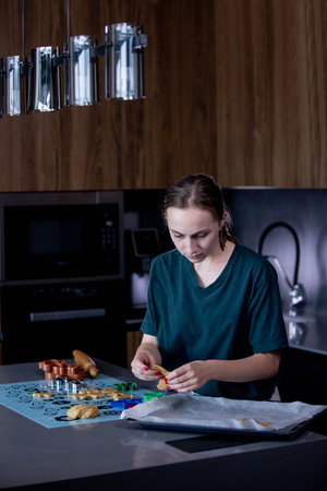 Young woman is making cookies in her kitchen.の写真素材