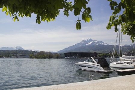 Lucerne is a city in central Switzerland. Tourist go to mount Rigi by boat on lake Lucerne. A panoramic view of the snow-capped Swiss Alps from the old part of Lucerne.の写真素材
