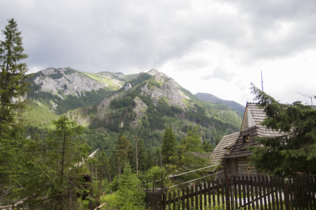 Wooden hut under Tatra mountains in Zakopane, Poland. Tatry at Poland and Slovakia. Near Marine Eye and Black Pond. Beautiful nature, lakes and rivers. Tatra Mountains National Park, Polandの写真素材