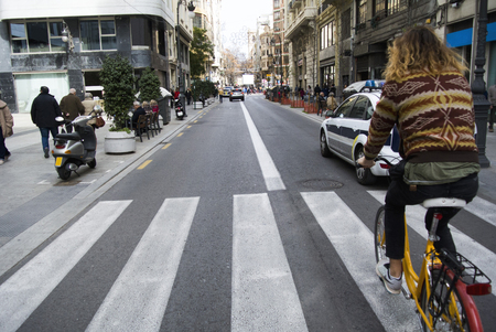 Cyclist hipster rides through the old town, Valencia, Spainの写真素材