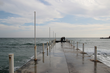 Empty pier on a cloudy day after a massive rainの写真素材