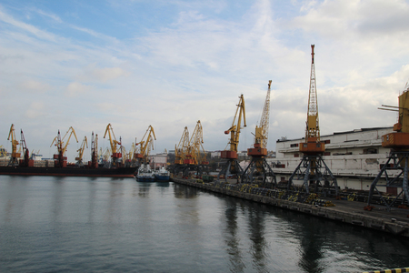 Logistics and transportation of Container Cargo ship and Cargo plane with working crane bridge in shipyard at Twilight sky, logistic import export background and transport industryの写真素材