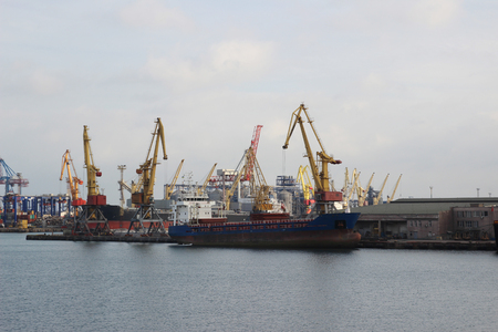 Logistics and transportation of Container Cargo ship and Cargo plane with working crane bridge in shipyard at Twilight sky, logistic import export background and transport industryの写真素材