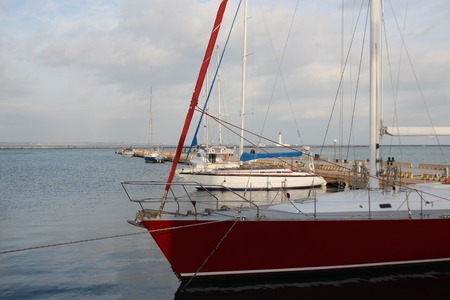 Small private yachts pier in winter Pier with rows of small private yachtsの写真素材