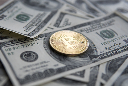 Golden Bitcoins on US dollars. Digital currency close-up. New virtual money. Crypto currency top view. Real coins of bitcoin on banknotes of one hundred dollars. Exchange. Bussiness, commercial.の写真素材