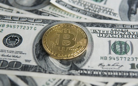 Golden Bitcoins on US dollars. Digital currency close-up. New virtual money. Crypto currency top view. Real coins of bitcoin on banknotes of one hundred dollars. Exchange. Bussiness, commercial.の写真素材