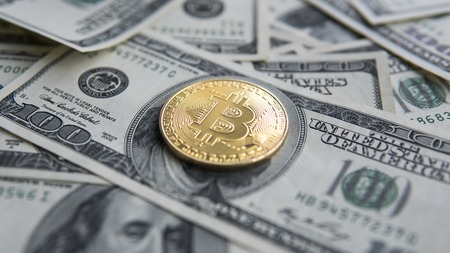 Golden Bitcoins on US dollars. Digital currency close-up. New virtual money. Crypto currency top view. Real coins of bitcoin on banknotes of one hundred dollars. Exchange. Bussiness, commercial.の写真素材
