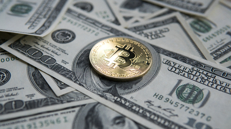 Golden Bitcoins on US dollars. Digital currency close-up. New virtual money. Crypto currency top view. Real coins of bitcoin on banknotes of one hundred dollars. Exchange. Bussiness, commercial.の写真素材