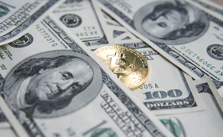 Golden Bitcoins on US dollars. Digital currency close-up. New virtual money. Crypto currency top view. Real coins of bitcoin on banknotes of one hundred dollars. Exchange. Bussiness, commercial.の写真素材