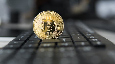 Golden bitcoin on a keyboard. Bitcoin crypto currency on a computer black keyboard. Digital currency. Virtual money. Metal coins of bitcoin. Bussiness, commercial, Exchange.の写真素材