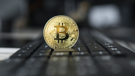 Golden bitcoin on a keyboard. Bitcoin crypto currency on a computer black keyboard. Digital currency. Virtual money. Metal coins of bitcoin. Bussiness, commercial, Exchange.の写真素材
