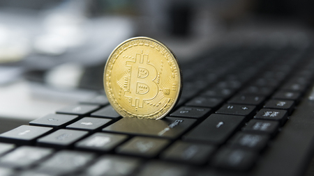 Golden bitcoin on a keyboard. Bitcoin crypto currency on a computer black keyboard. Digital currency. Virtual money. Metal coins of bitcoin. Bussiness, commercial, Exchange.の写真素材