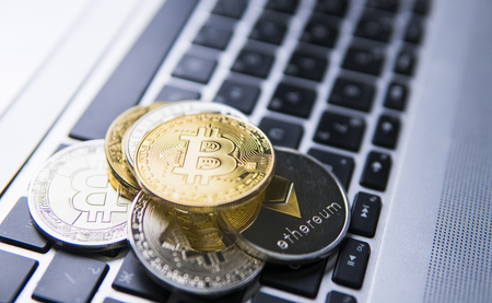 Bitcoin coin on a top of other crypto coins on a keyboard of laptop. Bitcoin golden coins. Cryptocurrency investment Digital currency. Virtual money. Metal coins of bitcoin. Bussiness, commercial.の写真素材