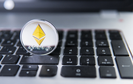 Ethereum coin on a laptop. Ethereum crypto currency on a laptop black keyboard. Digital currency. Virtual money. Metal coins of Ethereum. Bussiness, commercial, Exchange.の写真素材