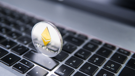 Ethereum coin on a laptop. Ethereum crypto currency on a laptop black keyboard. Digital currency. Virtual money. Metal coins of Ethereum. Bussiness, commercial, Exchange.の写真素材