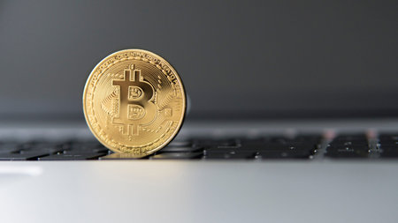 Golden bitcoin on a laptop. Bitcoin crypto currency on a computer black keyboard. Digital currency....