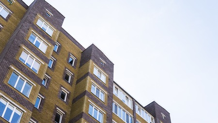 Modern, Luxury Apartment Building on a sunny day. Blu sky reflect in wundows of building.の写真素材