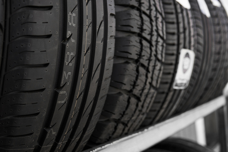 Protector of automobile tires. A number of automobile tires. Close up view on auto mobile new wheel tire surface. Different pattern and type tires for car industry commercial transport transpotration.の写真素材
