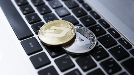 Silver and Gold Dash Cryptocurrency on laptop keyboard. Virtual money. Bussiness, commercial. Digital money and virtual crypto currency concept. Investment. Bussiness, commercial. Profit from mining.の写真素材