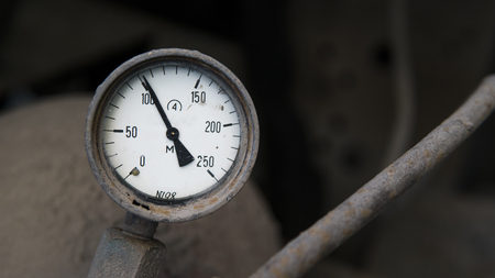 Industrial old white vintage barometer with old dirty gas cylinder.の写真素材