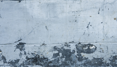 Blue concrete wall grunge texture with cracks. Cracks, scrapes, peeling old paint and plaster on background of old cement wall. An old cement stone wall as vintage cracked.の写真素材