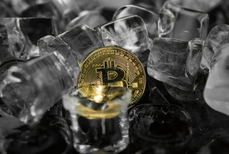 Gold bitcoin on ice background. The concept of the exchange in winter. Freeze. Blockchain mining....
