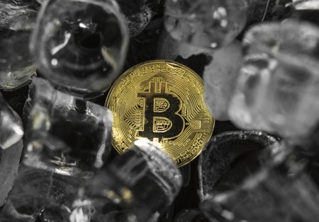 Gold bitcoin on ice background. The concept of the exchange in winter. Freeze. Blockchain mining. Digital money and virtual cryptocurrency concept. Iinvestment. Bussiness, commercial.の写真素材